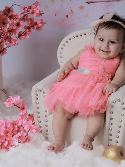 A happy smile from our cherry blossom princess. The pink floral theme creates a gentle and joyful atmosphere for her portraits.