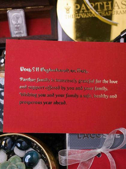 The personalized, gold-foiled note card included in the Parthas corporate hamper, expressing gratitude to their valued clients.