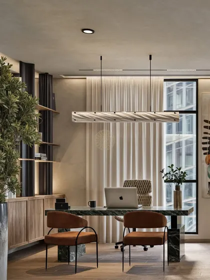 A private cabin should be both a workspace and a retreat. In this design, we used a statement green marble desk, a sculptural light fixture, and warm wood shelving to create a leadership space that feels powerful, personal, and comfortable for a long day's work.
