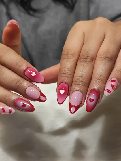 A full view of the playful Valentine's Day nails, with a mix of aura hearts and lipstick kiss patterns.