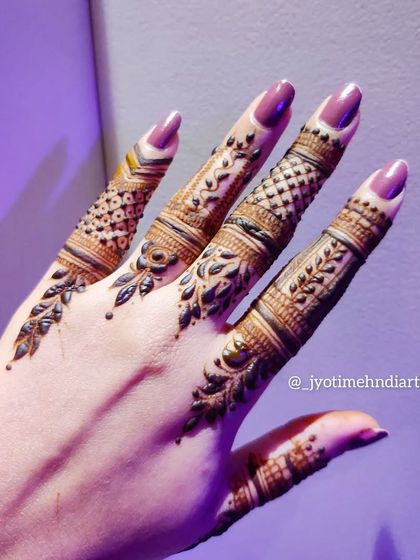 Detailed finger patterns are a great way to have henna without committing to a full hand design. Each finger here has a unique, intricate pattern.
