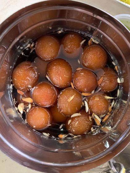 A comforting bowl of homemade Gulab Jamuns, soaked in sweet syrup and garnished with almonds. A classic Indian dessert that I love to prepare for special occasions.