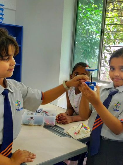 Two girls at TSGM collaborate to build a flying machine, demonstrating creativity and teamwork. We encourage students to think outside the box and bring their ideas to life.