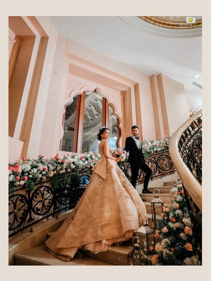 A fairytale moment on the grand staircase of The Leela Palace Bengaluru. I lined the stairs with cascading arrangements of pink and white flowers and soft lanterns to create a romantic pathway for the couple.