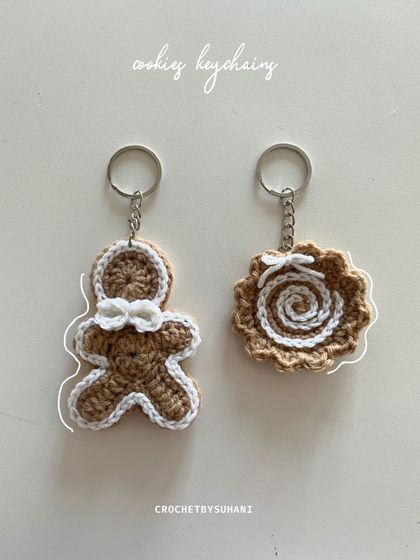 My Christmas-themed cookie keychains, featuring a gingerbread man and a swirl cookie design. These festive charms are perfect for the holiday season or as a sweet treat for your keys year-round.