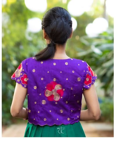 The back of the violet jacket is just as beautiful, with scattered floral motifs and a scalloped edge.