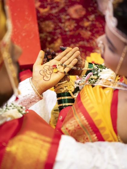 An overhead shot capturing the bride admiring the 'mangalsutra' in her hand, a symbol of her new marital status.