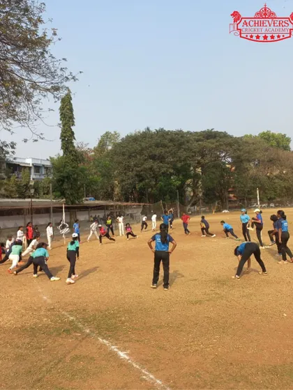 A wide shot of the girls participating in warm-up and fielding drills during the selection day.