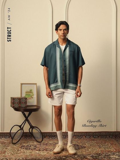 A lookbook image for menswear brand Struct, featuring their Cigarillo Bowling Shirt. The set was styled with vintage props to create a classic, leisurely feel that aligns with the collection's theme.