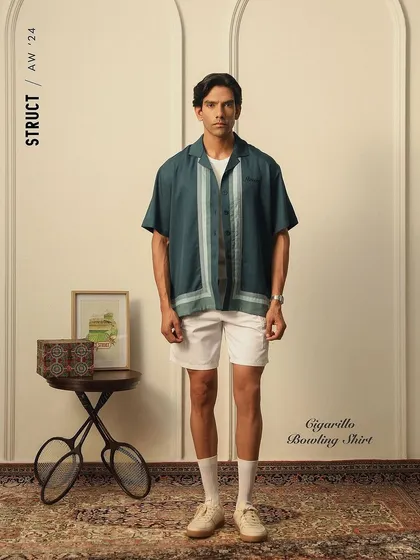 A lookbook image for menswear brand Struct, featuring their Cigarillo Bowling Shirt. The set was styled with vintage props to create a classic, leisurely feel that aligns with the collection's theme.