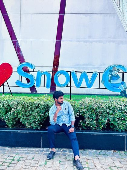 Posing with the "I Love Snow City" sign at the entrance.