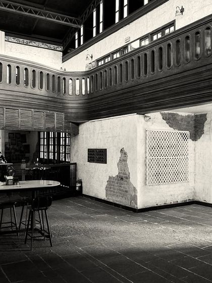 A wide view of the ground floor, showing how different seating areas are zoned using furniture and low railings.