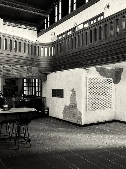 A wide view of the ground floor, showing how different seating areas are zoned using furniture and low railings.