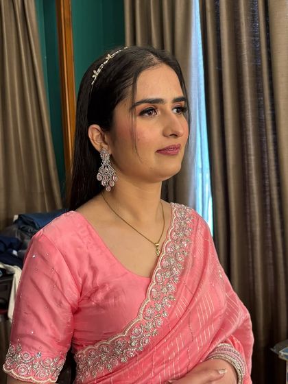 Another shot of the client in her pink saree, showing the elegant makeup from a different angle.