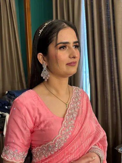 Another shot of the client in her pink saree, showing the elegant makeup from a different angle.