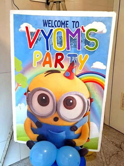 A personalized welcome sign for 'Vyom's Party' with a cute Minion character. These custom details make the birthday boy or girl feel extra special.