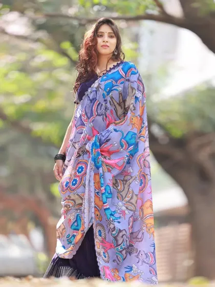 This three-quarter shot shows the model holding the printed dupatta, drawing attention to its colorful design. The natural outdoor setting makes the colors pop.