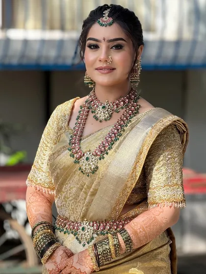 A smiling portrait of the bride, looking radiant and ready for her big day. The makeup is fresh and enhances her joyful expression.