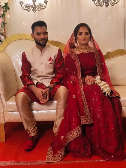 The same couple seated on their wedding stage. My makeup ensures they both look fresh and photogenic throughout the long hours of the ceremony and reception.