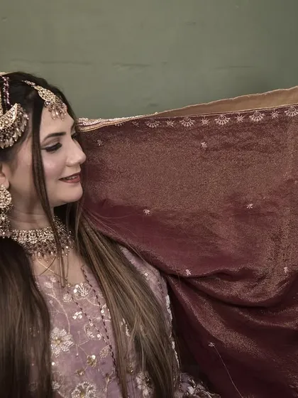 A side profile of the engagement bride, showing off her beautiful jewellery and the soft contour of her makeup.