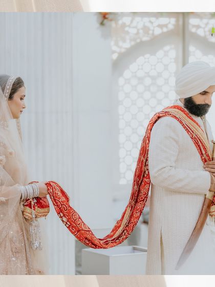 The sacred 'palla rasam' during an Anand Karaj ceremony, where the bride's father hands her palla to the groom, symbolizing their union.