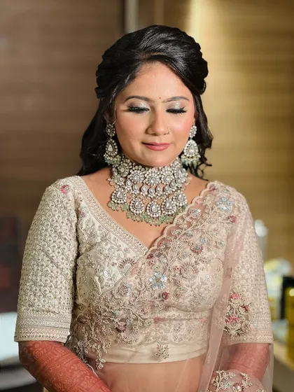 A beautiful reception look featuring soft, shimmery makeup and a stunning curly hairstyle.