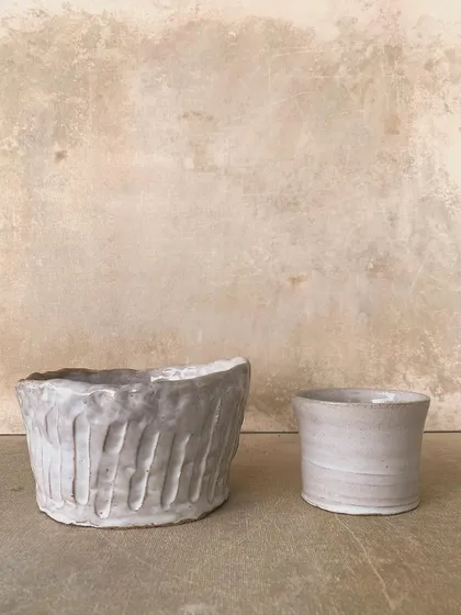 A textured bowl and a smooth cup, side-by-side. A study in contrasts, both beautiful in their own way.