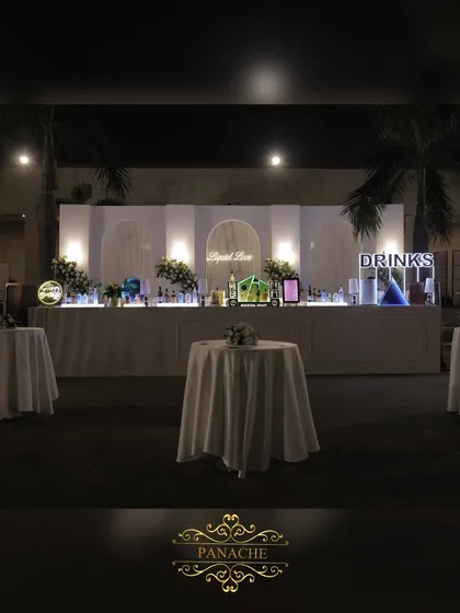 The bar for the cocktail night, an elegant all-white setup with a neon "Liquid Love" sign. We ensure every element, including the bar, is beautifully integrated into the decor.