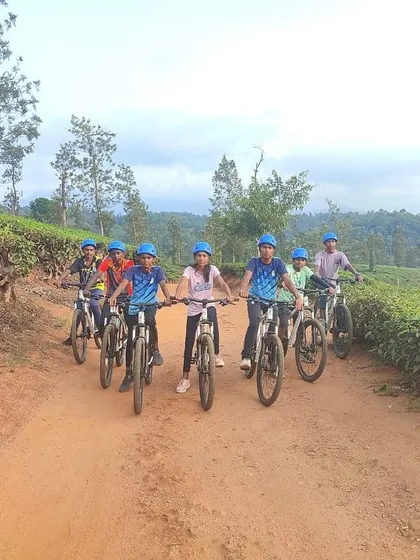 A team of young girls on mountain bikes ready to explore the dirt tracks and scenic routes of Barapole.