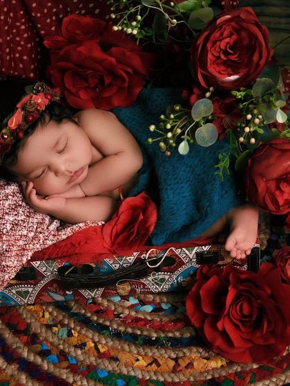 A dramatic and passionate portrait with deep red roses. The rich colors and textures give this image a classic, almost painterly quality.