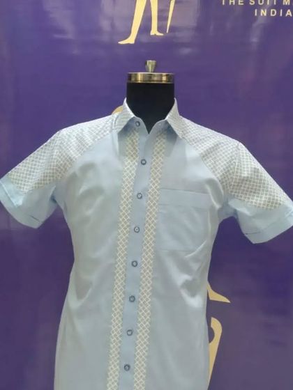 A light blue custom half-sleeve shirt with a checkered panel design. It's a subtle way to add some pattern and personality to your everyday wardrobe.