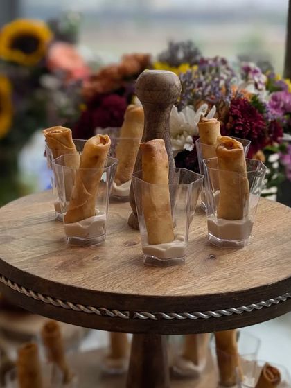 My signature Truffle Cigar Rolls, elegantly served in individual glasses on a rustic wooden stand. They were a highlight at the Varnya salon launch.