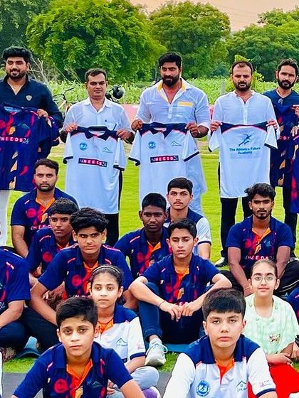 A group photo with sponsors and guests holding up the new jerseys for The Athletics Future Academy.