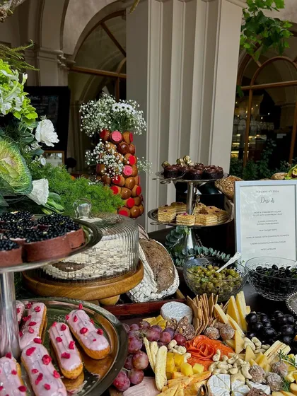 Another detail shot of the brunch table, with pink eclairs, caviar tarts, and a tower of profiteroles.