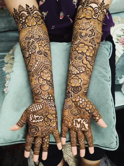 This bridal design was personalized with the groom's name, 'Maaz', and the couple's initials, 'MA', on the palms.