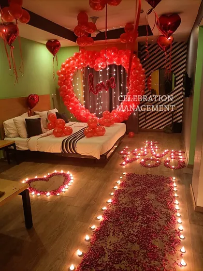 This is the ultimate romantic gesture. We filled this room with love, using a large heart-shaped balloon arch over the bed, a candle-lit pathway of rose petals, and hundreds of red balloons to create a completely immersive and passionate atmosphere.