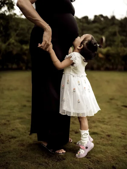 Moments like these are my absolute favorite. The pure, unscripted love of a big sister meeting her sibling for the first time, a gentle kiss to the baby bump. This is what family maternity photography is all about, capturing the bonds that are already forming.