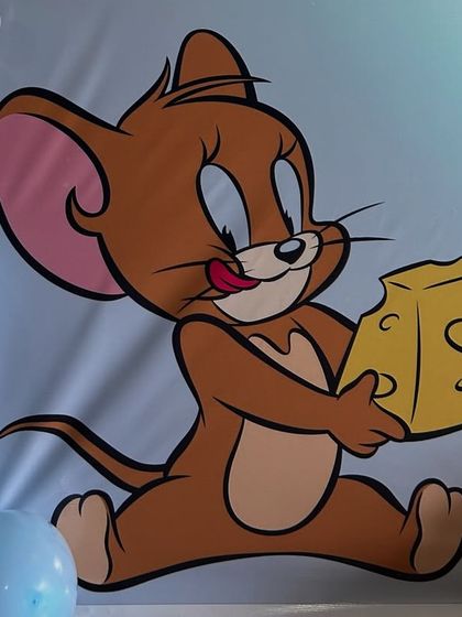 A close-up of the Jerry character on the custom backdrop for our Tom and Jerry party theme.