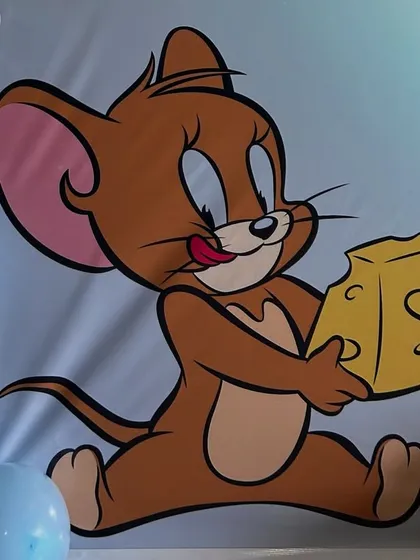 A close-up of the Jerry character on the custom backdrop for our Tom and Jerry party theme.
