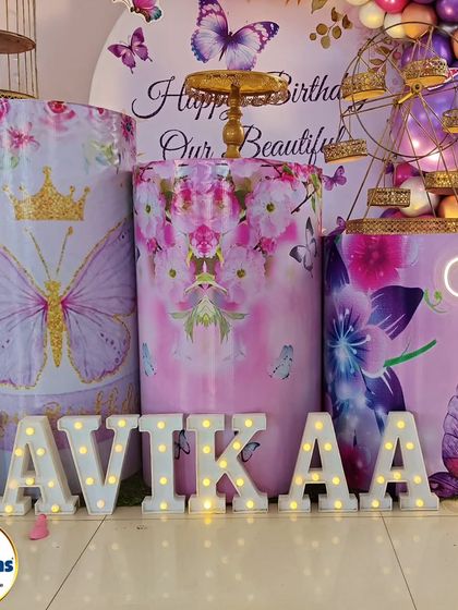 A close-up of the marquee letters for a butterfly-themed party, showing the custom-printed plinths.