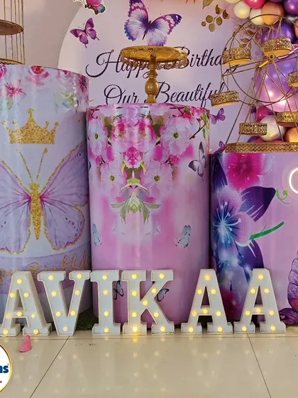 A close-up of the marquee letters for a butterfly-themed party, showing the custom-printed plinths.