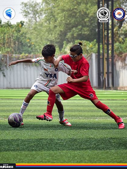 A tense moment as two players challenge for the ball. Our league is full of these exciting, hard fought battles.