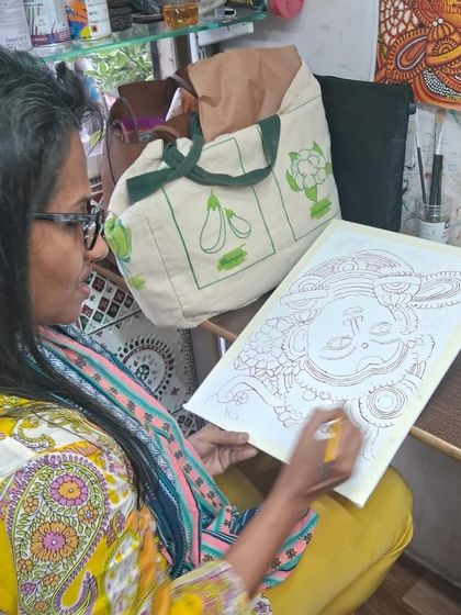 The first step in creating a mural is the drawing. Here, a student carefully sketches the outline of her design, laying the foundation for the painting to come.