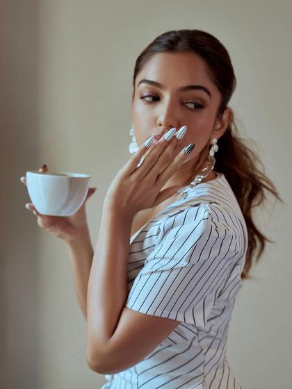 A different vibe with these black and white striped press-on nails. This look is more graphic and playful, showing the range of styles we can create for any occasion.