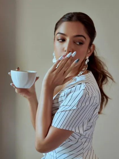 A different vibe with these black and white striped press-on nails. This look is more graphic and playful, showing the range of styles we can create for any occasion.