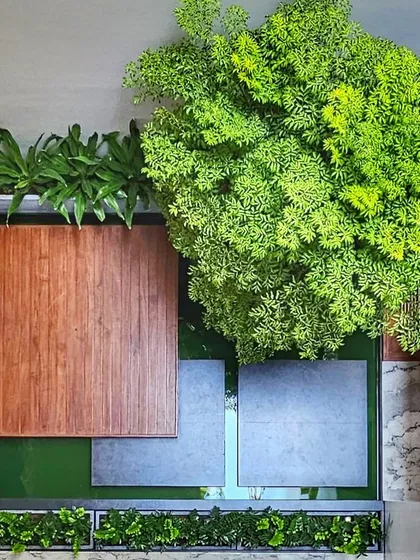 A bird's-eye view of an internal courtyard, where water, wood, stone, and greenery come together. We design these pockets of nature to bring tranquility and life into the very core of the home.