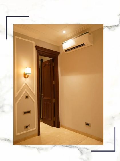 This simple yet elegant shot of a bedroom corner with classic wall moulding and a rich wooden door shows that you deserve more than a house; you deserve a masterpiece.