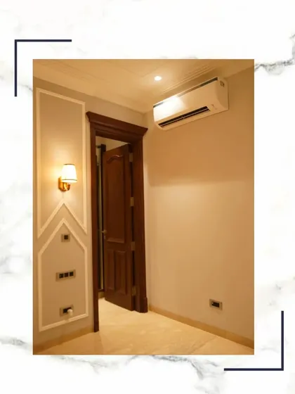 This simple yet elegant shot of a bedroom corner with classic wall moulding and a rich wooden door shows that you deserve more than a house; you deserve a masterpiece.