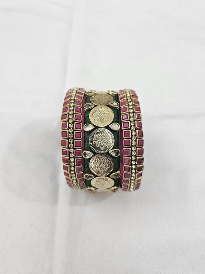 Different angles showcasing the craftsmanship of the green and ruby silk thread bridal bangle set with antique coin details.