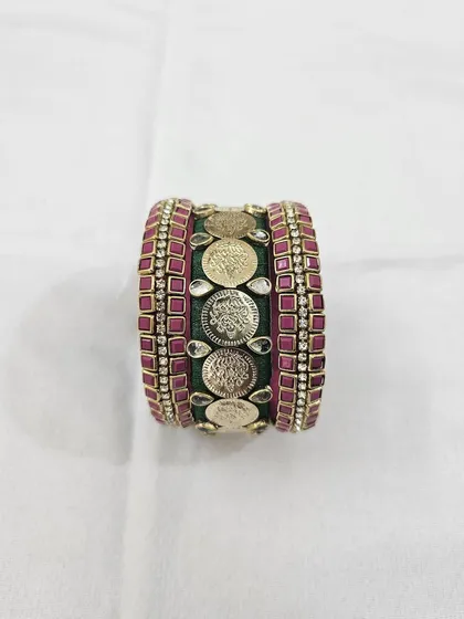 Different angles showcasing the craftsmanship of the green and ruby silk thread bridal bangle set with antique coin details.